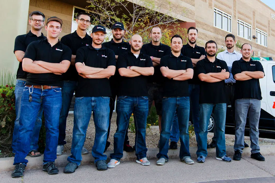 Team of technicians standing outside office building