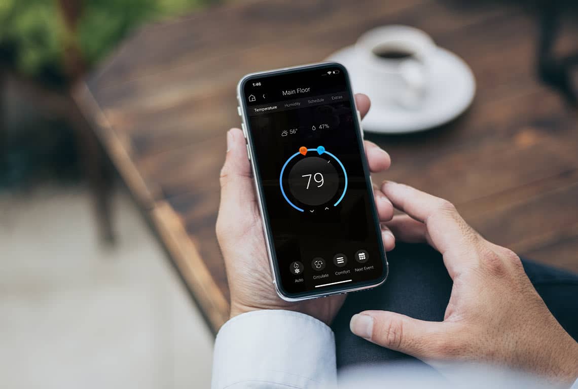 Person checking smart home thermostat app