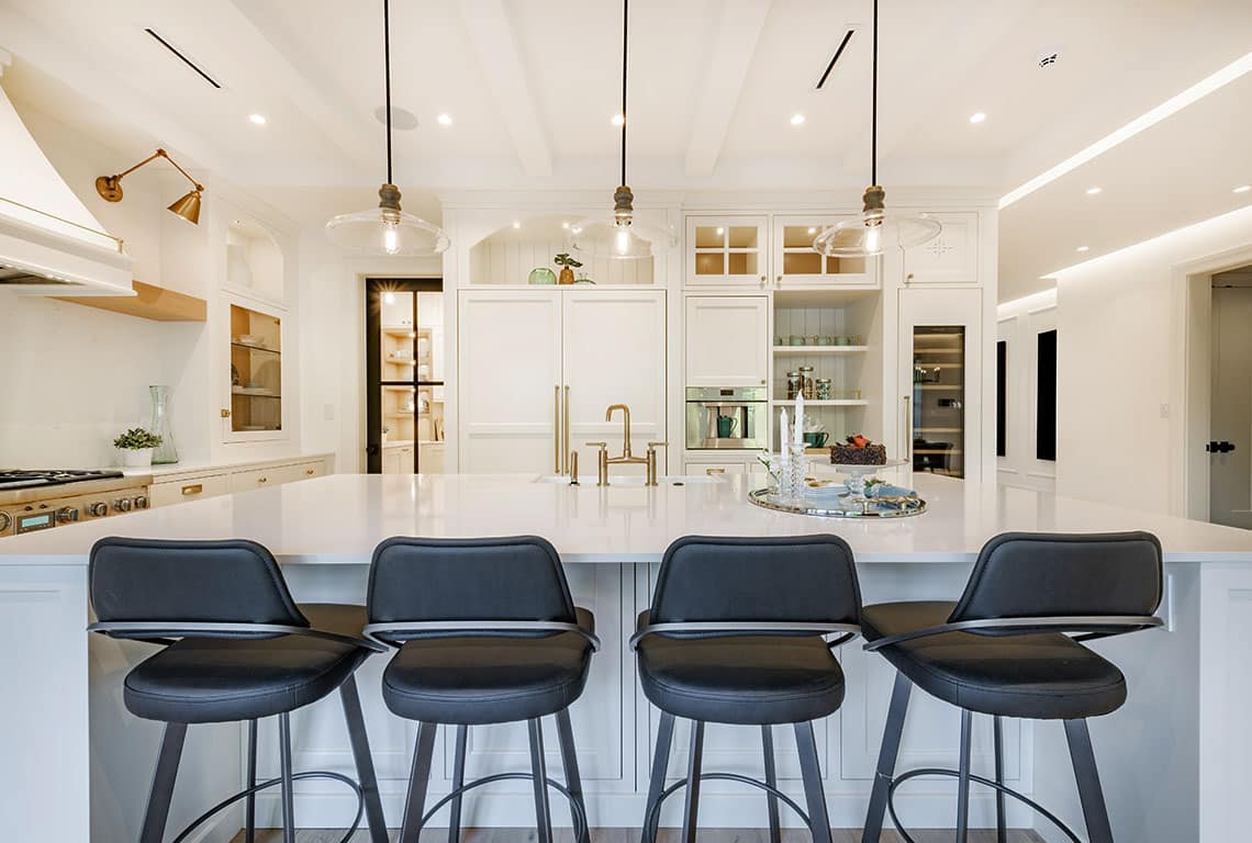 Modern white kitchen with island and bar stools