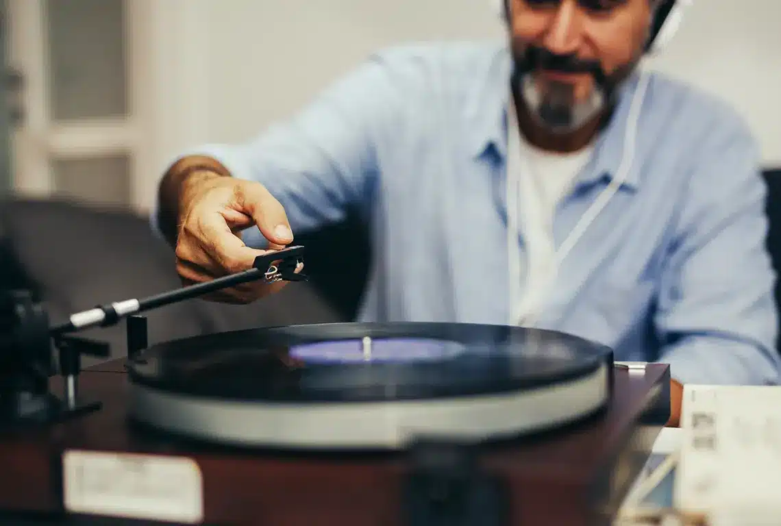 Man playing music on a vinyl record player