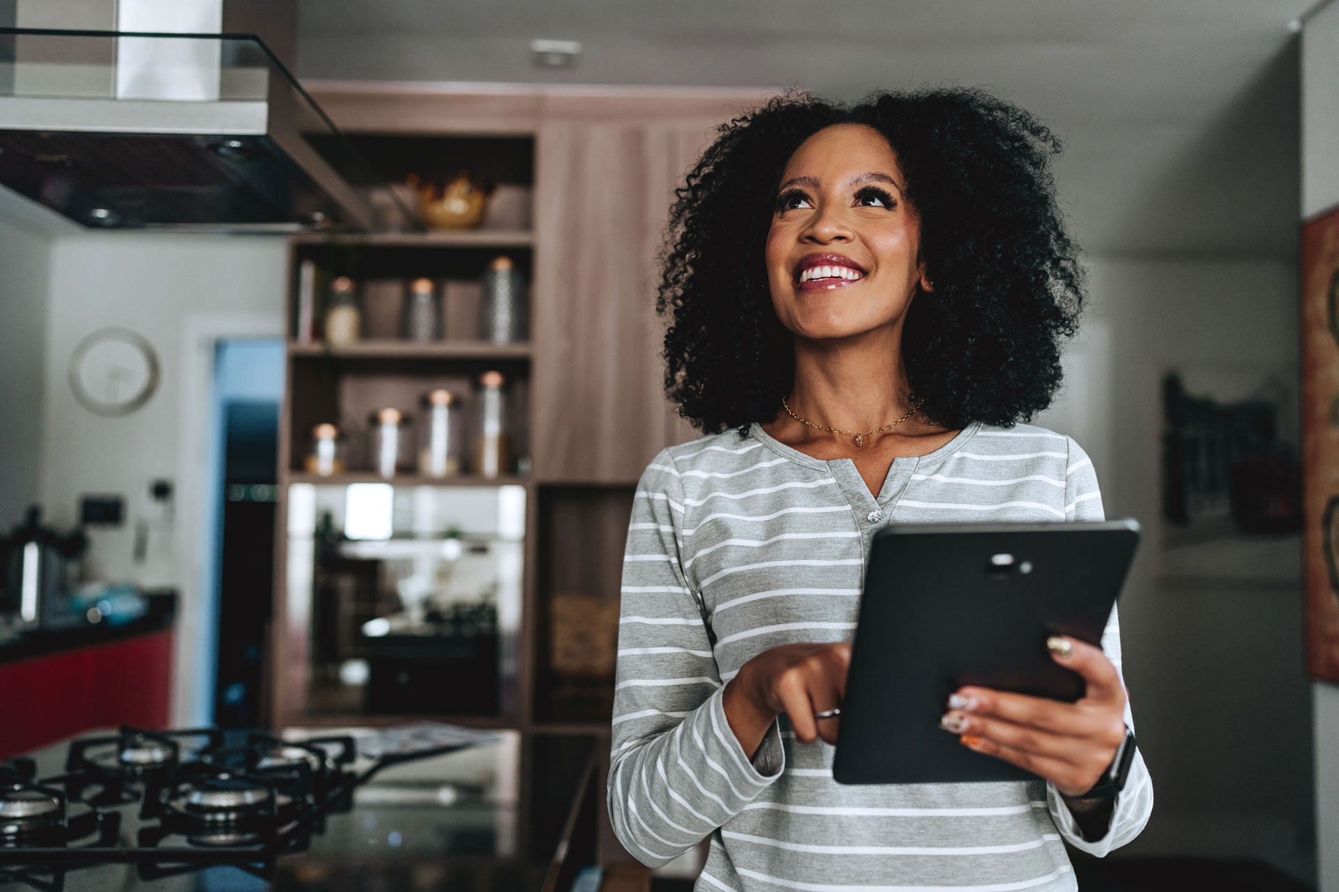 Woman using tablet in modern kitchen