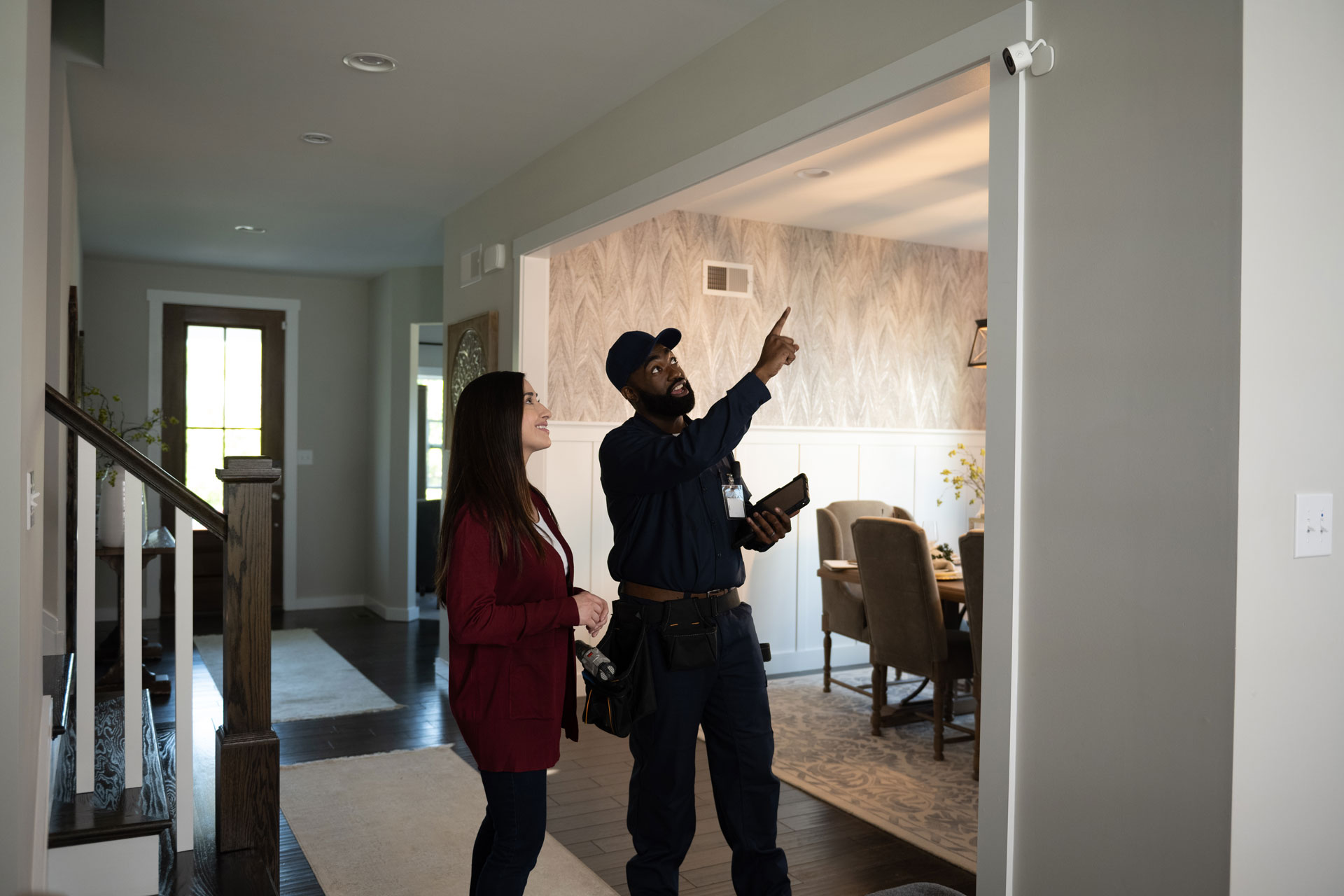 Technician showing homeowner indoor security camera