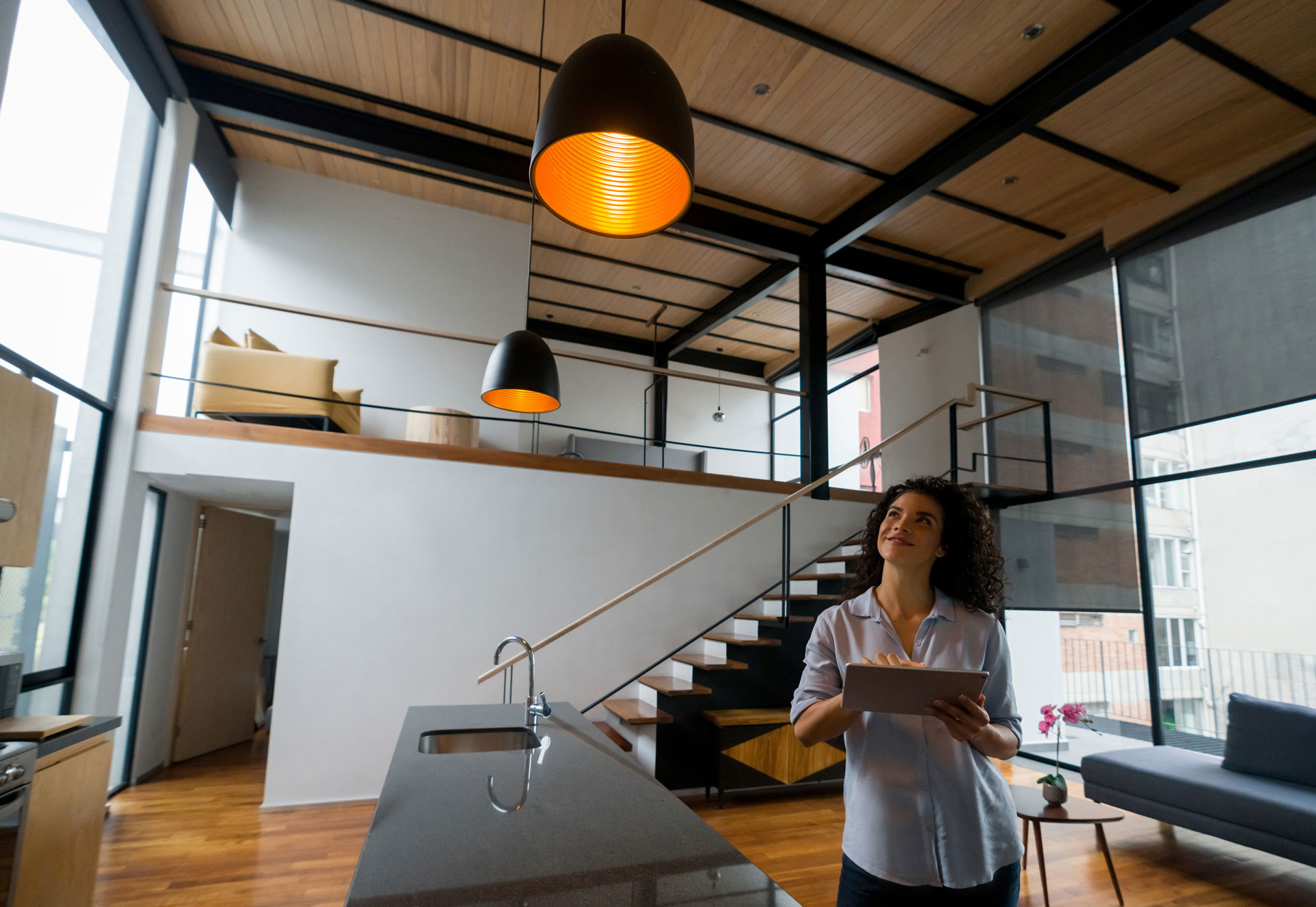 Woman using tablet in modern loft apartment