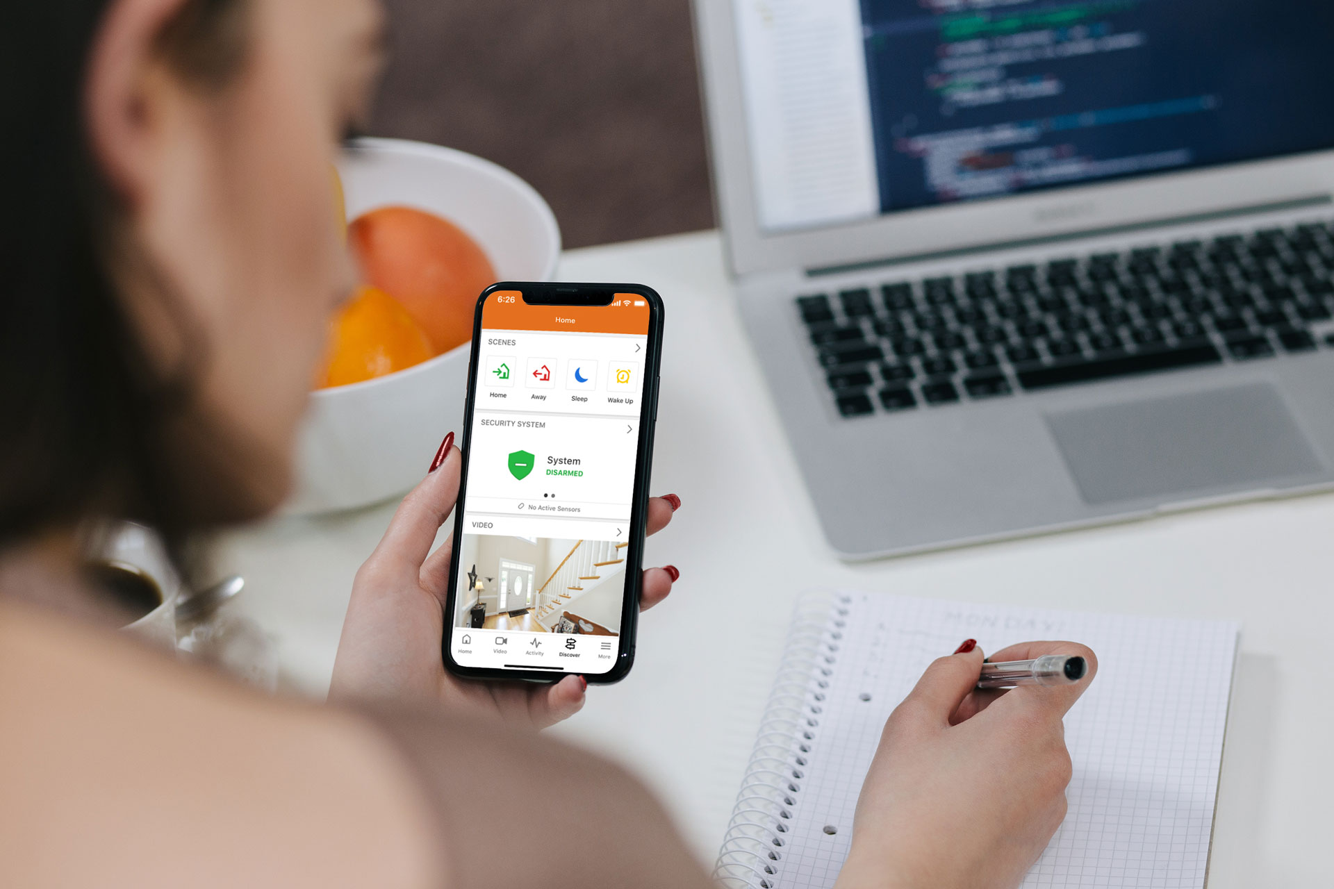 Person using smartphone smart home security app