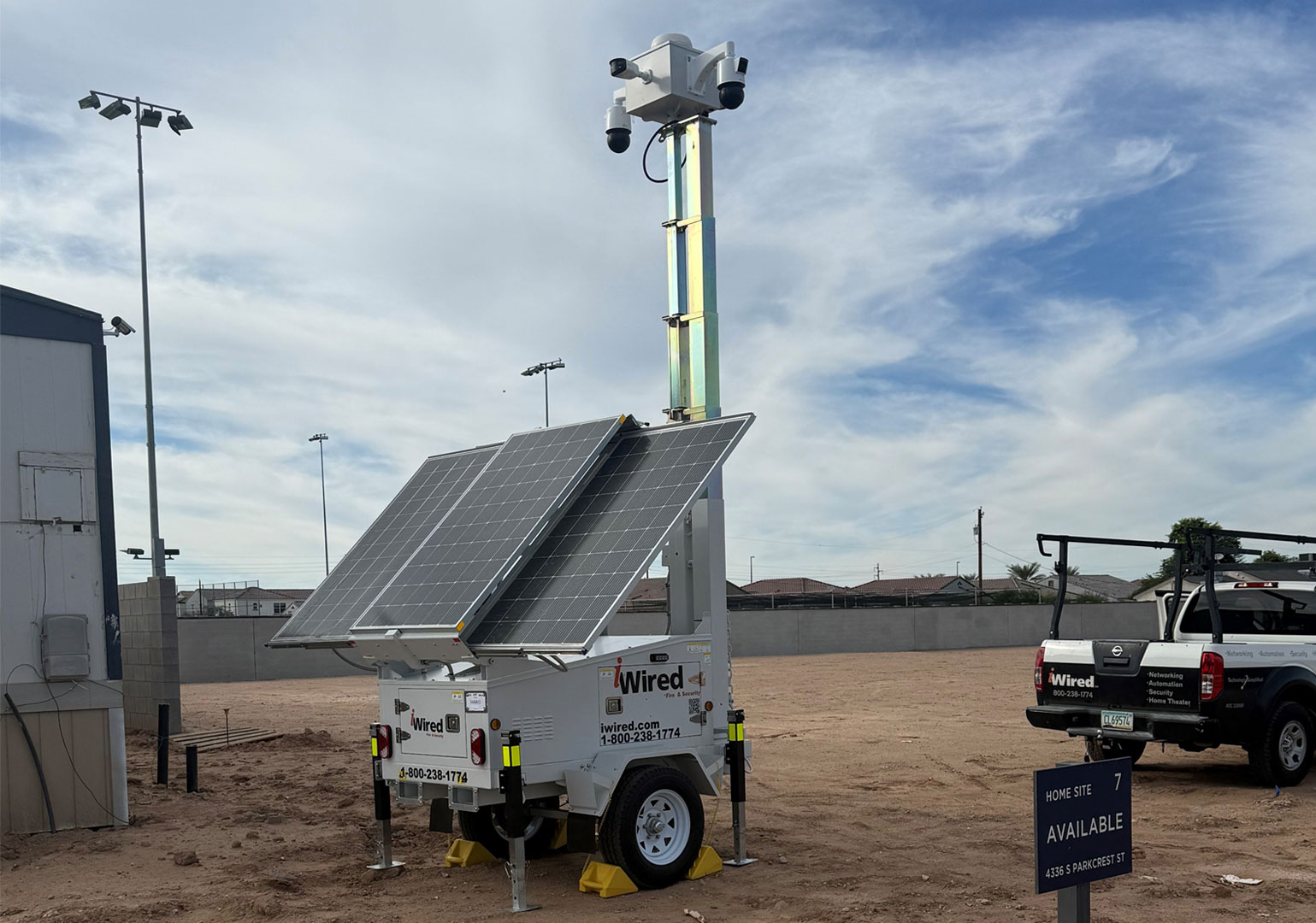 Mobile solar-powered surveillance camera trailer in empty lot