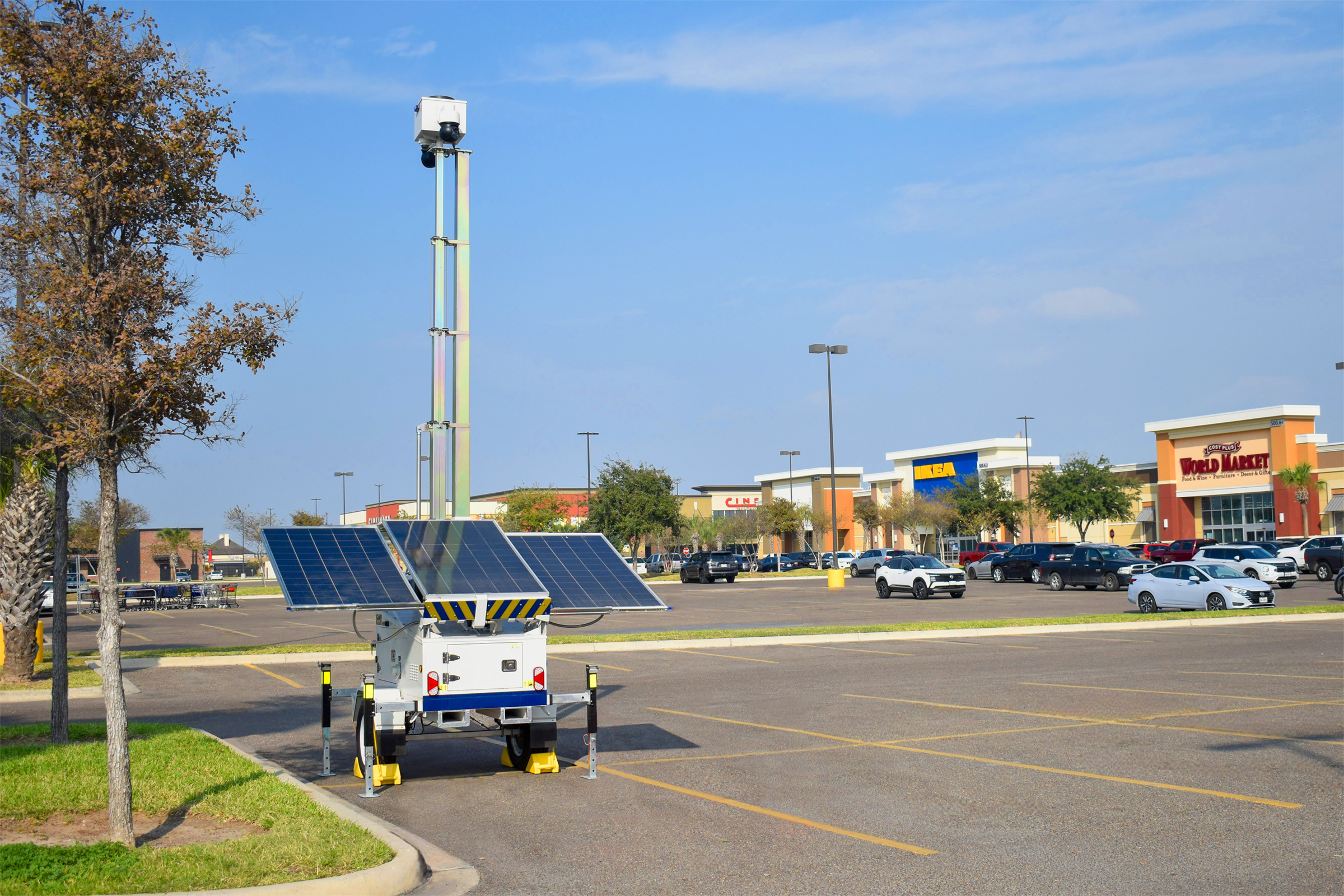 Solar-powered security tower in shopping center parking lot