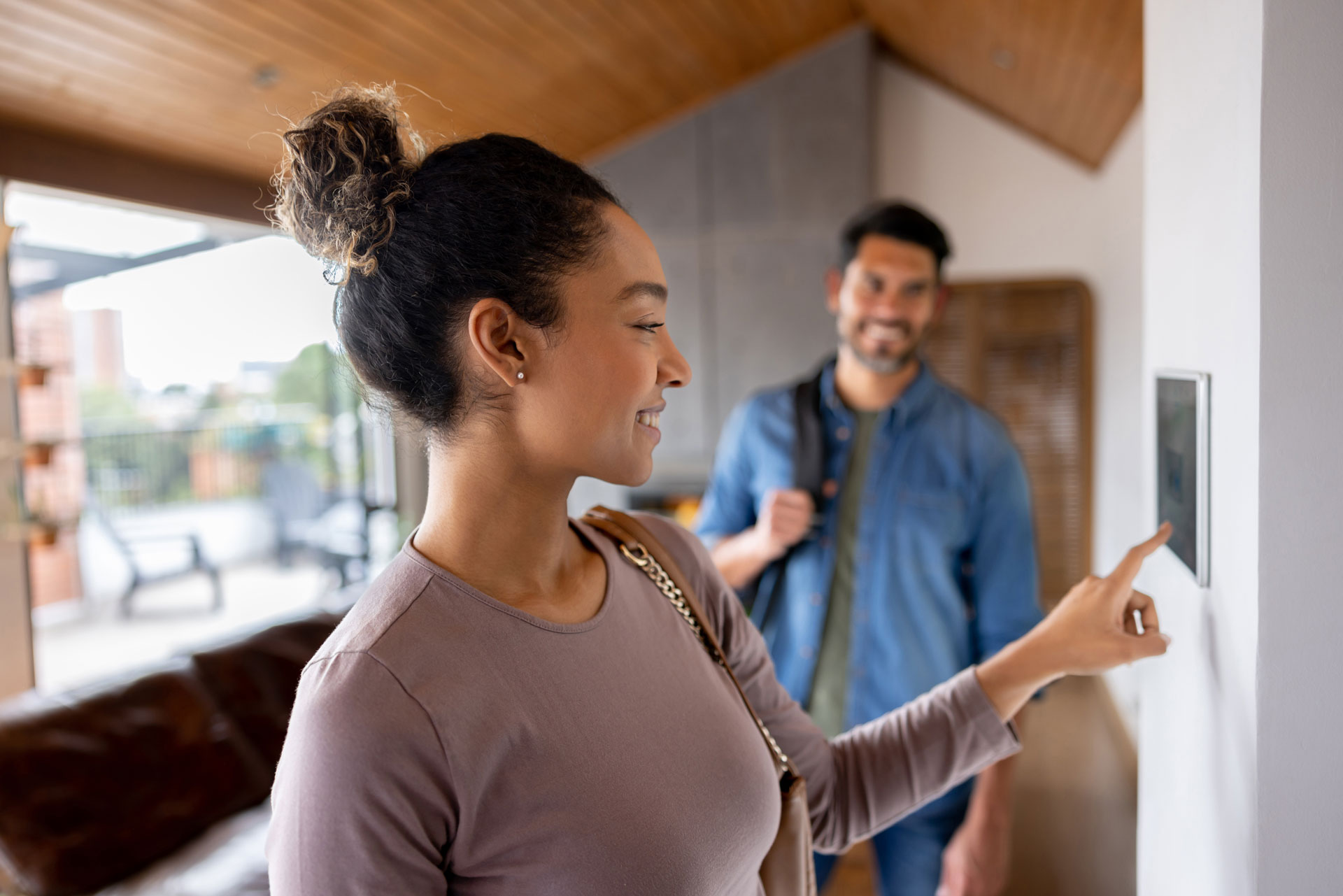 Woman using smart home control panel